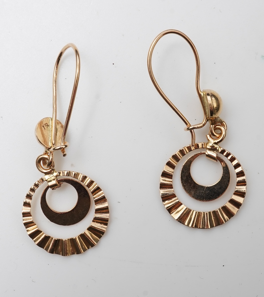 A gold necklace and pair of earrings
